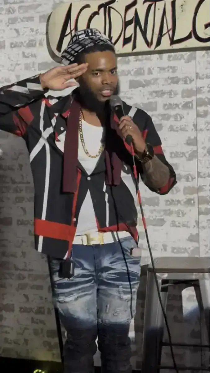 KingJu1c3 saluting on stage with a microphone
